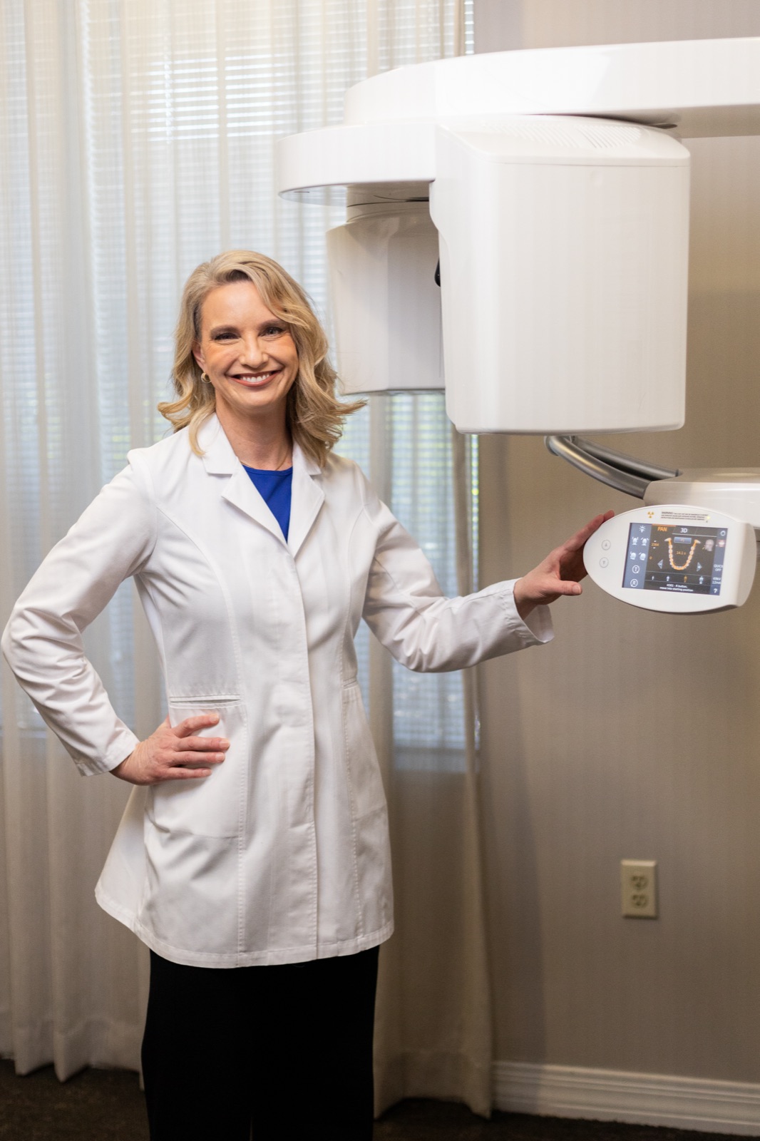 Dr. Allison House beside the cone beam CT scanner