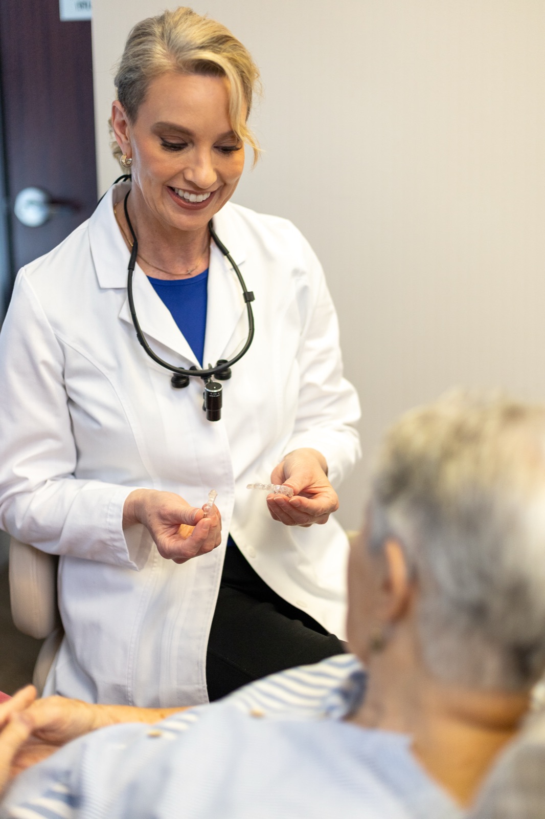 Dr. House presenting custom oral appliances to a patient