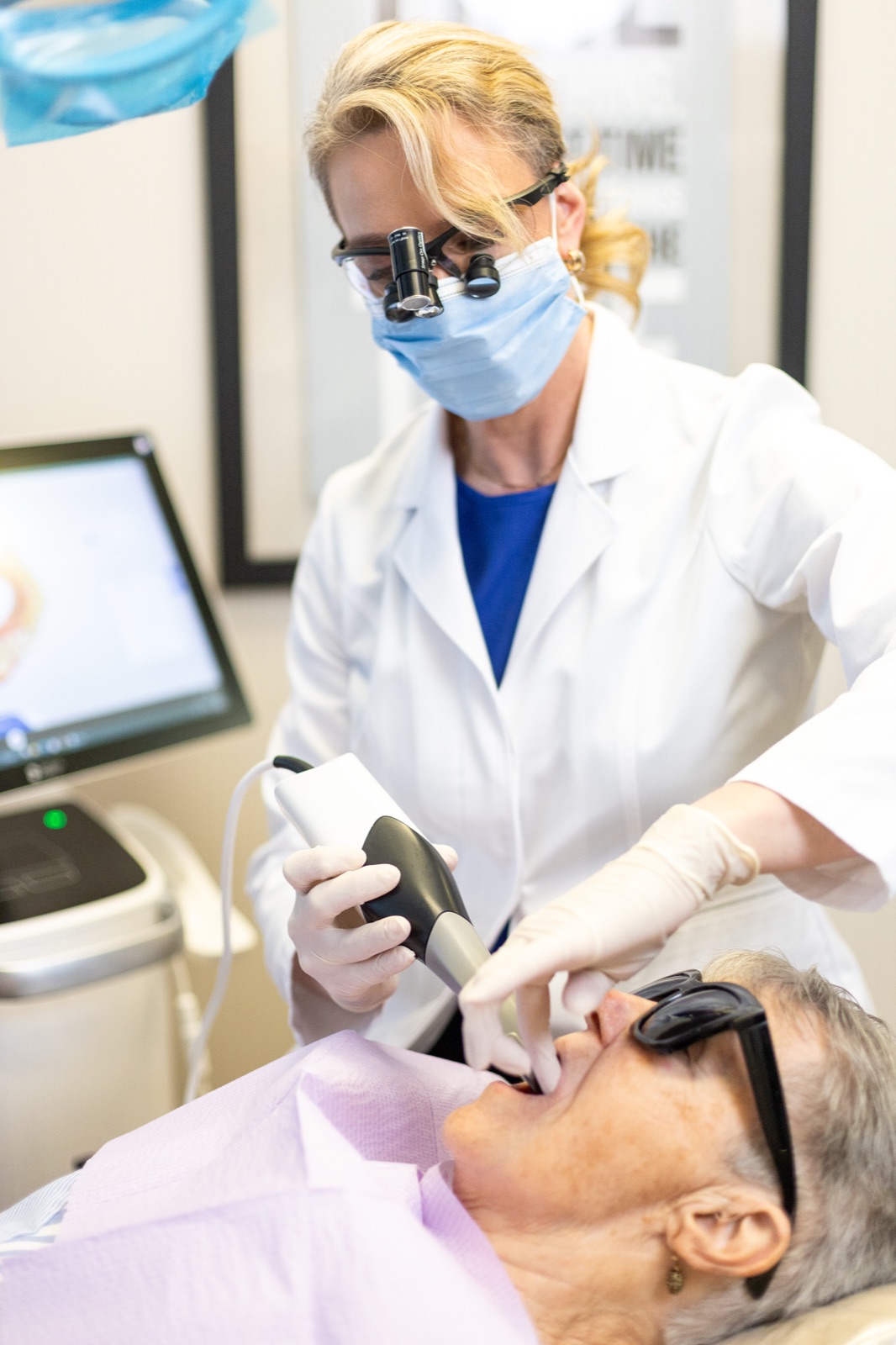 Dr. House using a digital scanner chairside during a same-day crown visit