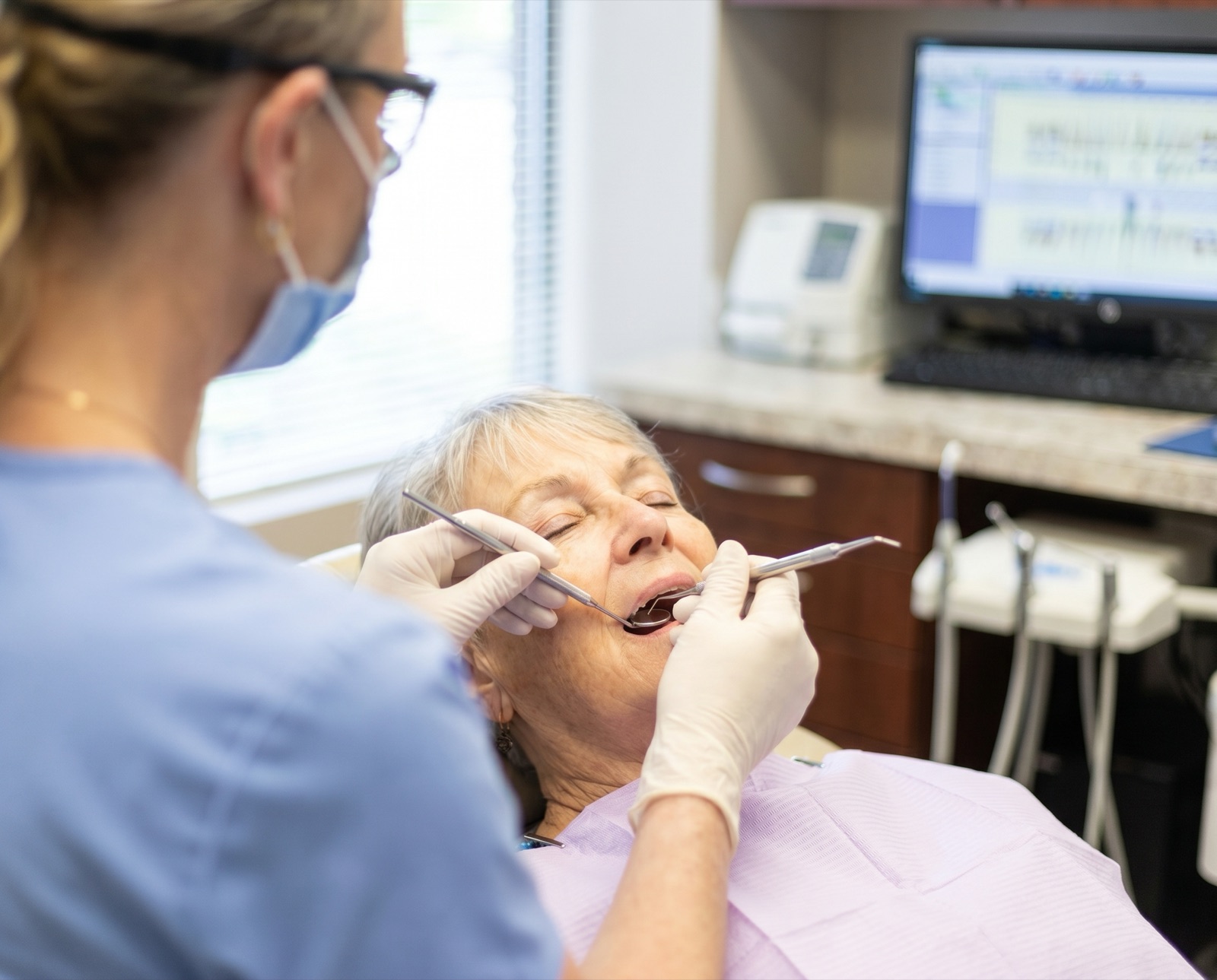 A hygienist performing a gentle professional teeth cleaning